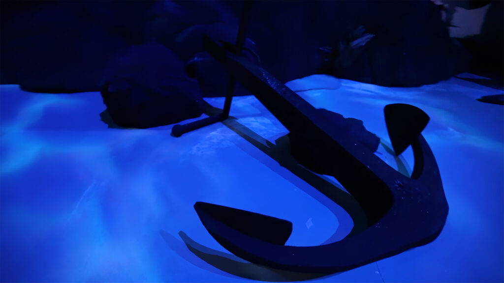 Ancre géante posée sur un sol projeté façon fond marin dans l’installation immersive Panerai à Shanghai.